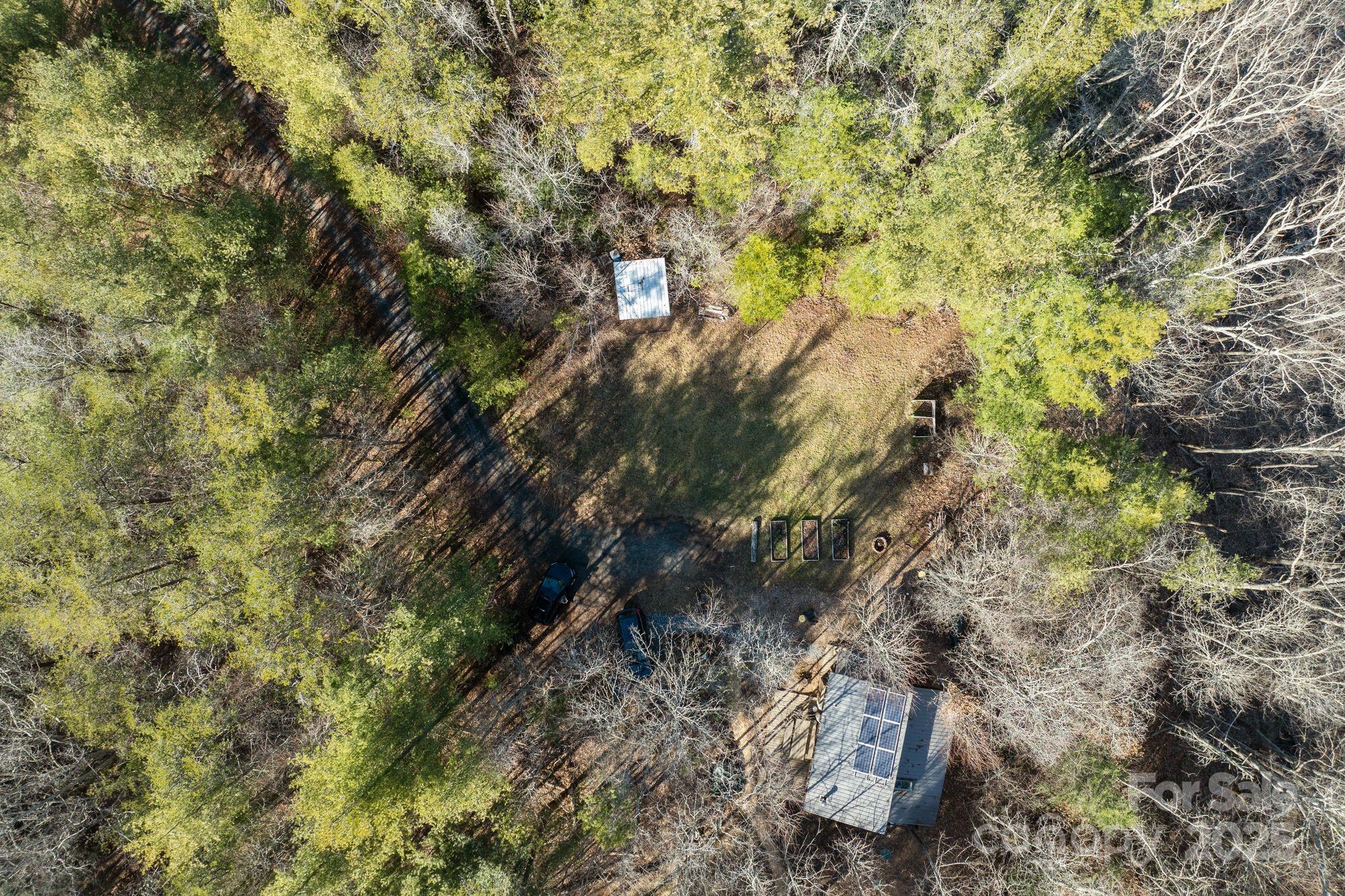 131 Ivy Blfs Road, Unit 3 Marshall, NC 28753 - Photo 2 of 24 a backyard of a house with lots of trees