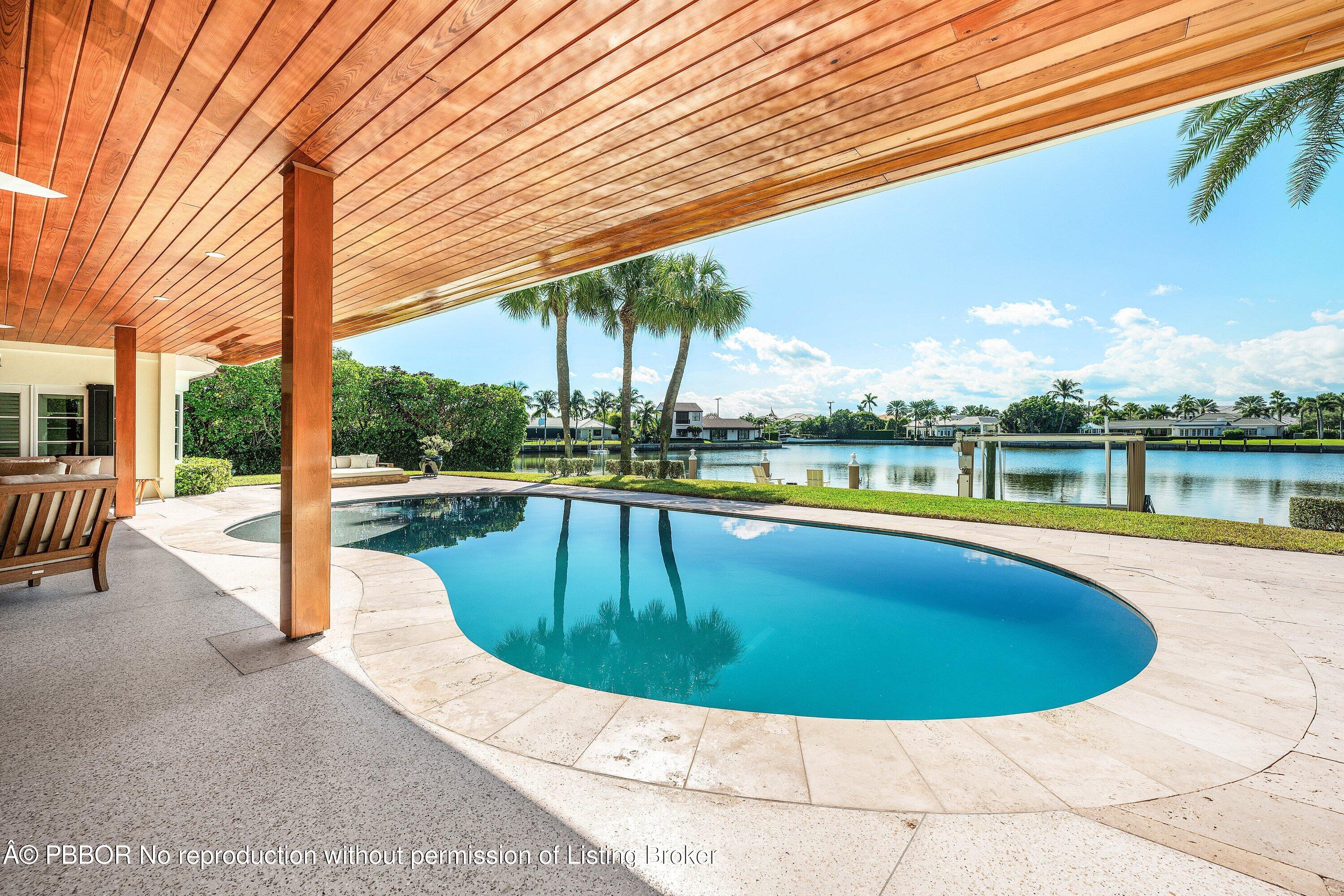 50 Spoonbill Road Lantana, FL 33462 - Photo 4 of 37 a view of a swimming pool with an outdoor seating