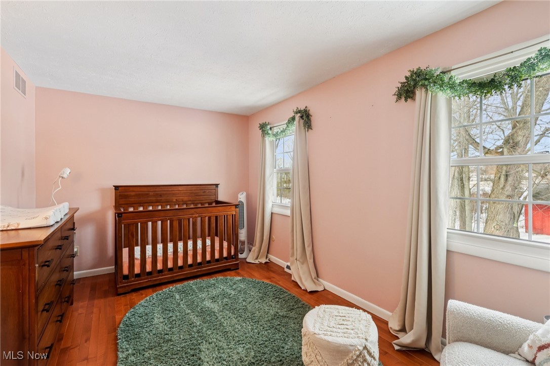 445 Center Road Hinckley, OH 44233 - Photo 28 of 50 Bedroom featuring a crib and hardwood / wood-style flooring