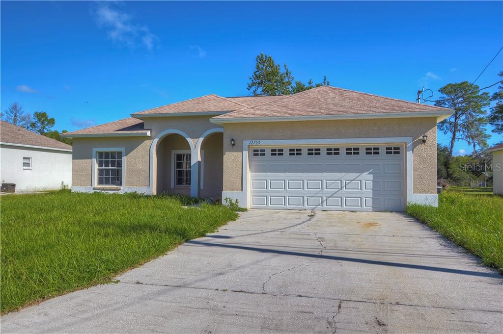 12729 Valimar Road New Port Richey, FL 34654 - Photo 1 of 1 a front view of a house with yard