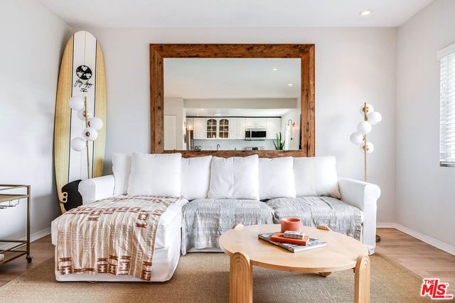 a living room with furniture and a mirror