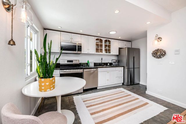 a kitchen with a refrigerator and a sink
