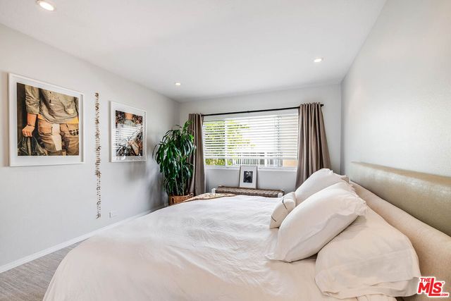 a bedroom with a large bed and a large window