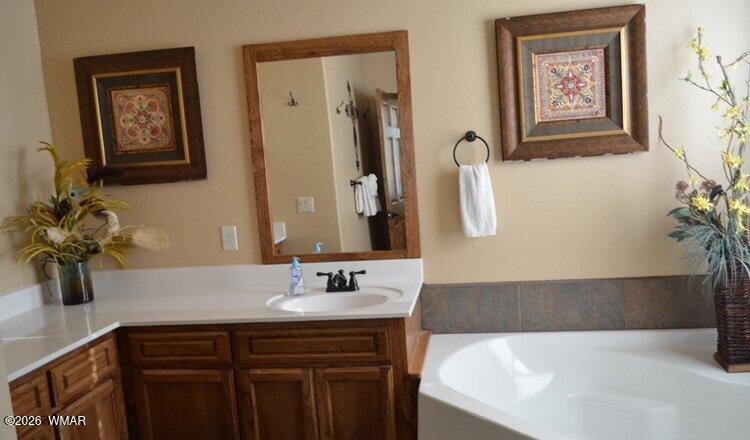 285 Main Street Eagar, AZ 85925 - Photo 12 of 18 a bathroom with a tub sink and mirror