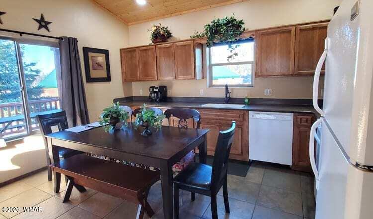 285 Main Street Eagar, AZ 85925 - Photo 6 of 18 a kitchen with a table chairs refrigerator and microwave