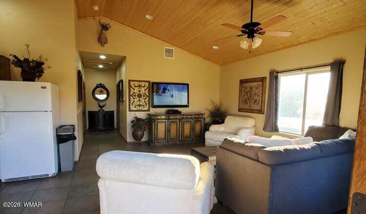 285 Main Street Eagar, AZ 85925 - Photo 8 of 18 a living room with furniture and a flat screen tv