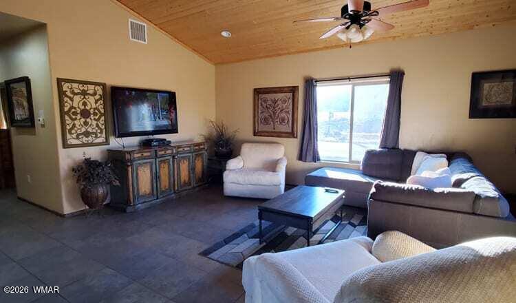 285 Main Street Eagar, AZ 85925 - Photo 9 of 18 a living room with furniture and a flat screen tv