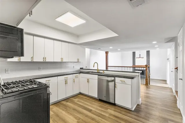 a kitchen with stainless steel appliances granite countertop a stove and a sink