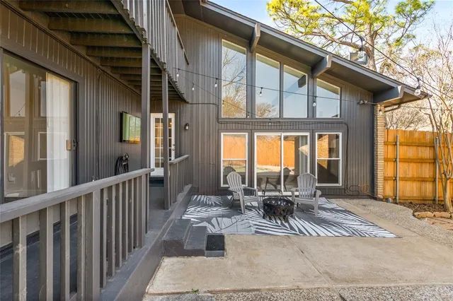 a view of a patio with table and chairs