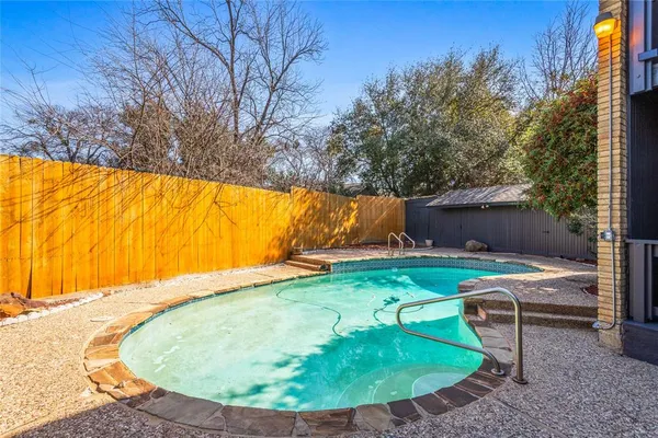 a view of backyard with swimming pool