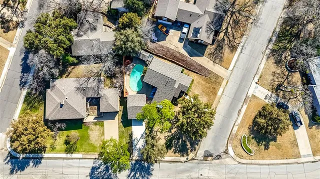 an aerial view of residential houses with outdoor space