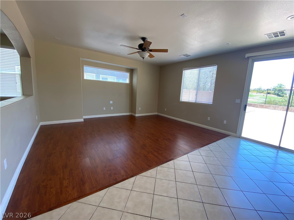 489 Foster Springs Road Las Vegas, NV 89148 - Photo 7 of 30 A versatile living space with a blend of rich wood and cool tile flooring, extending to a bright outdoor patio.