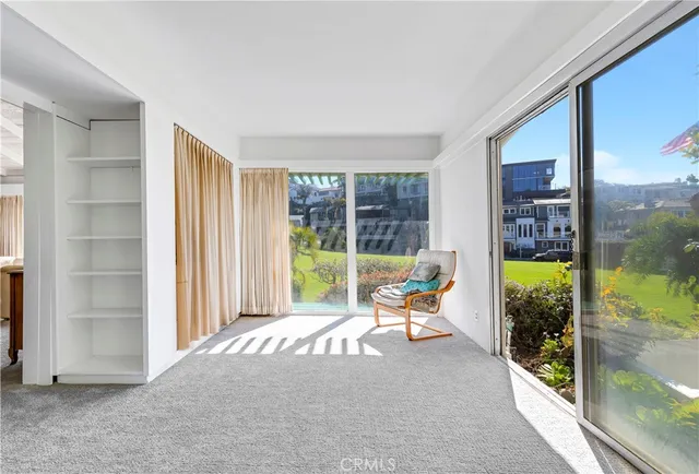 a living room with furniture and a floor to ceiling window