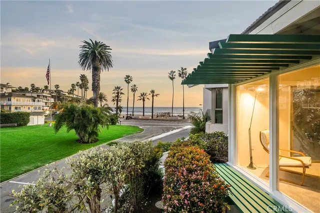 a view of a patio with a table and chairs next to a yard