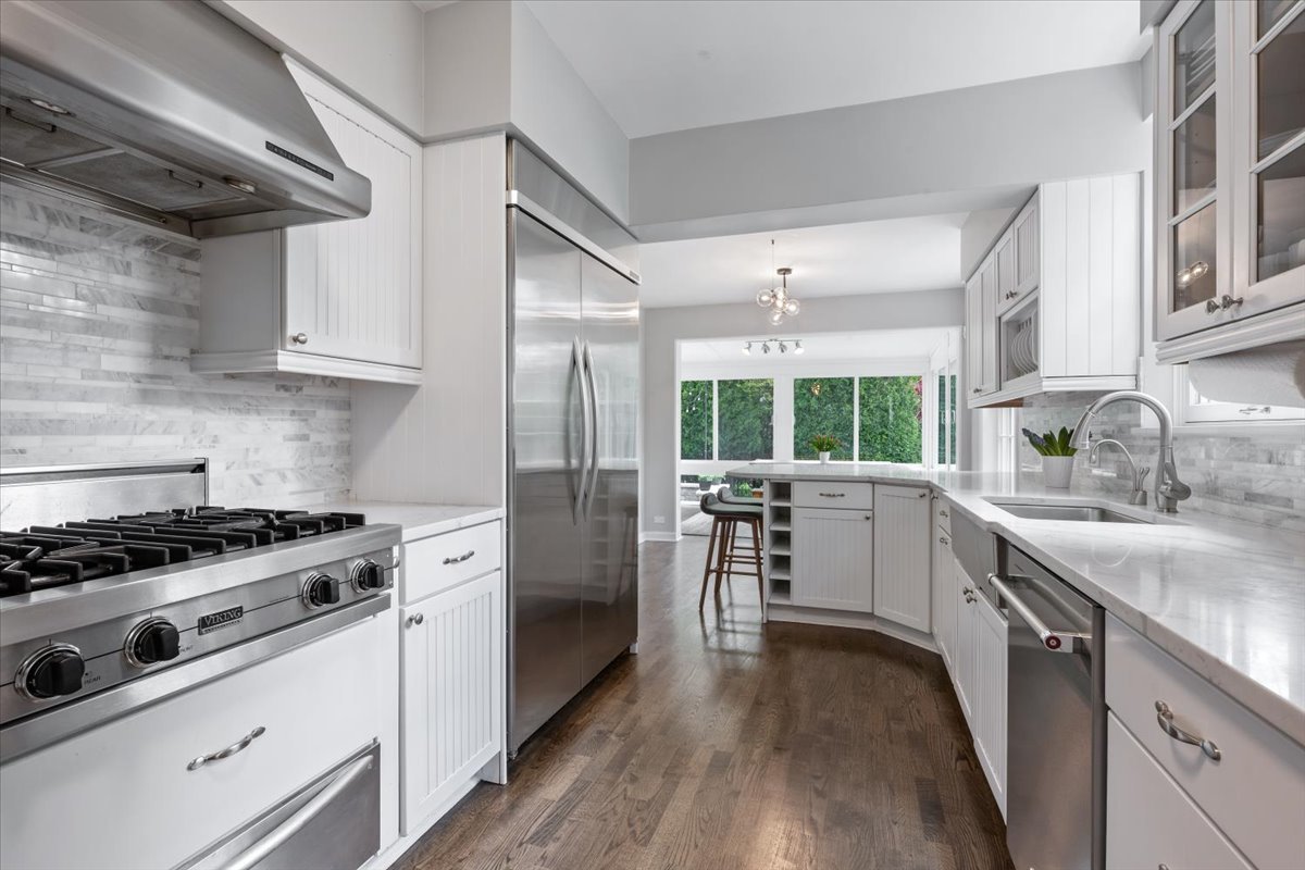 910 Chippewa Lane Wilmette, IL 60091 - Photo 14 of 38 a kitchen with white cabinets and appliances