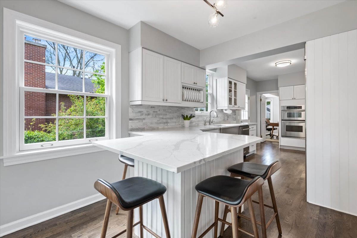 910 Chippewa Lane Wilmette, IL 60091 - Photo 15 of 38 a kitchen with a table chairs a sink dishwasher window and cabinets