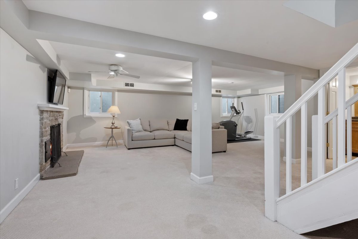 910 Chippewa Lane Wilmette, IL 60091 - Photo 27 of 38 a living room with furniture and a fireplace