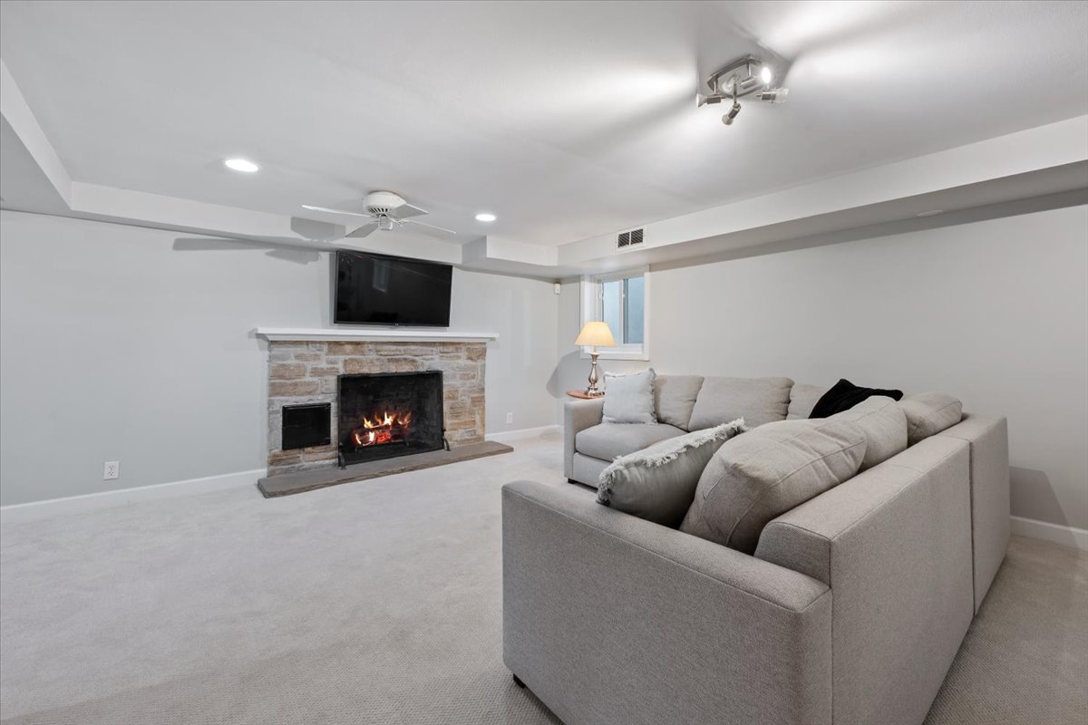 910 Chippewa Lane Wilmette, IL 60091 - Photo 28 of 38 a living room with furniture a flat screen tv and a fireplace