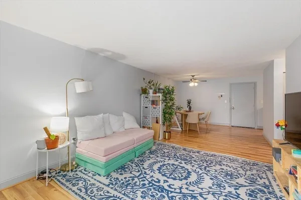 a living room with furniture and wooden floor