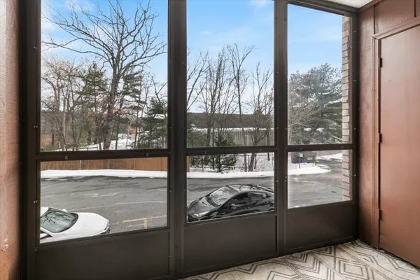a view of a glass door with a tv from a window