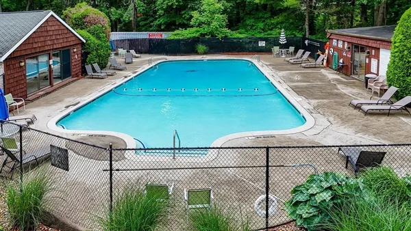 a view of a swimming pool with patio