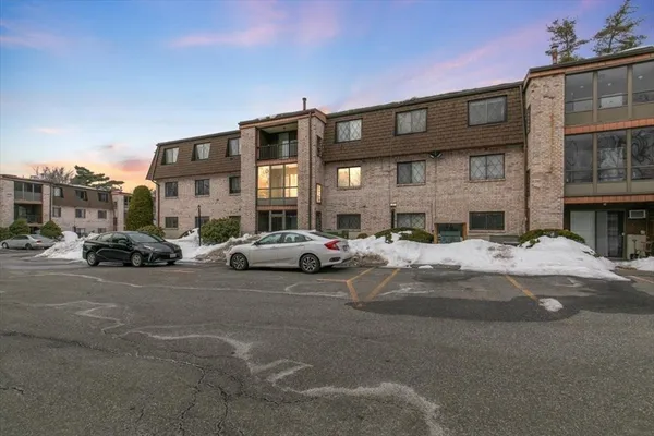 a view of a street that has couple of cars parked on the road