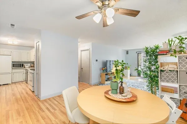 a dining room with furniture and a chandelier