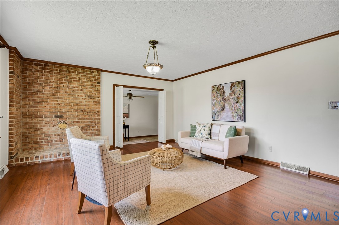 Wood-finish flooring throughout, with a brick wall