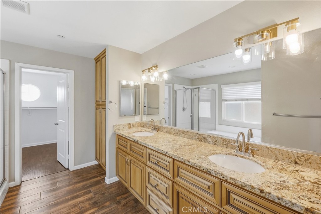 956 West Tibbot Street Rialto, CA 92377 - Photo 27 of 37 a bathroom with a granite countertop double vanity sink and mirror