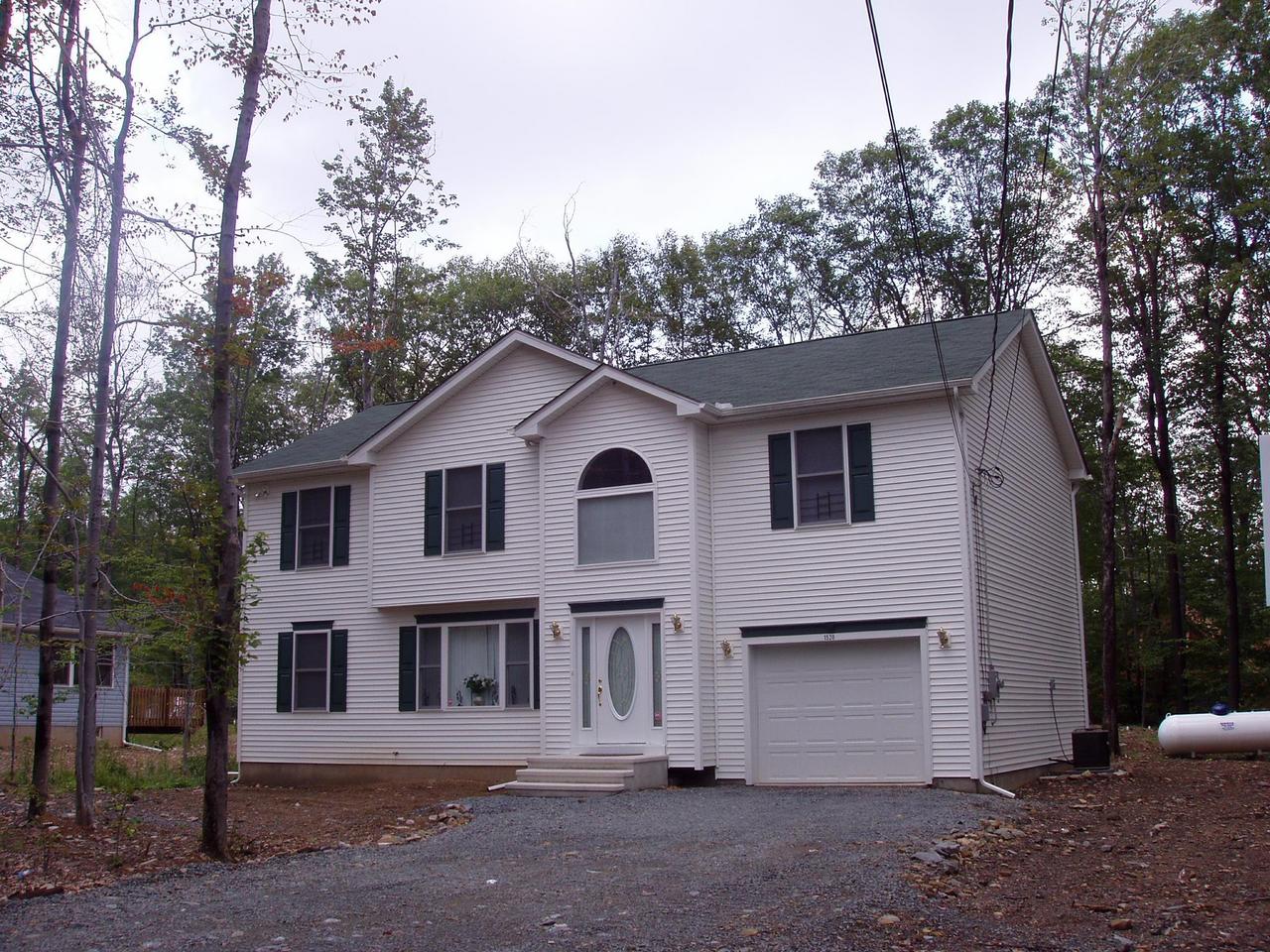 1117 Titania Road Tobyhanna, PA 18466 - Photo 3 of 8 a view of a white house with large trees