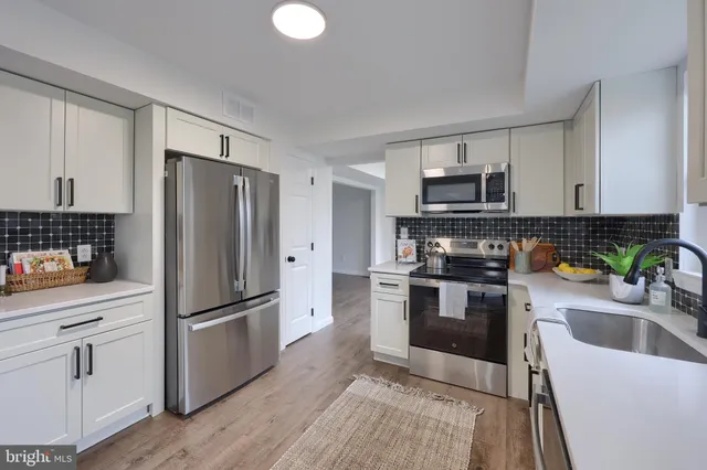 a kitchen with a sink stove and cabinets