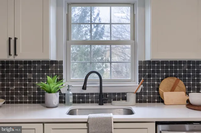 a kitchen with stainless steel appliances a refrigerator and a stove top oven