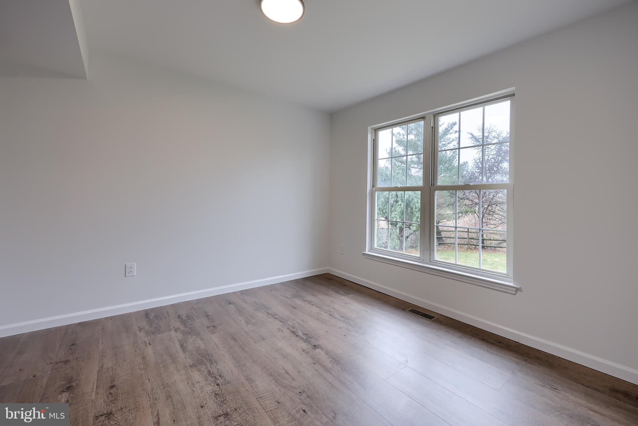 40 Gunpowder Lane Reading, PA 19606 - Photo 41 of 59 an empty room with wooden floor and windows