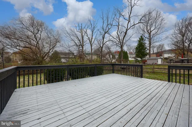 a front view of a house with a garden and yard