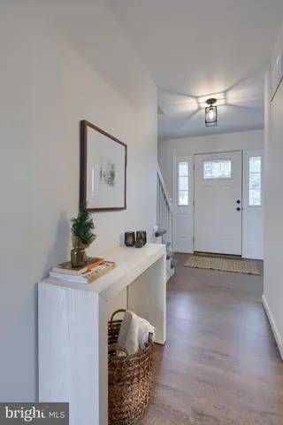 a room with a table chairs and wooden floor