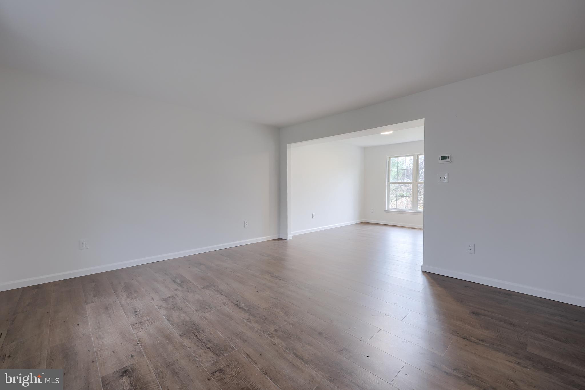 40 Gunpowder Lane Reading, PA 19606 - Photo 9 of 59 a view of an empty room with wooden floor and a window