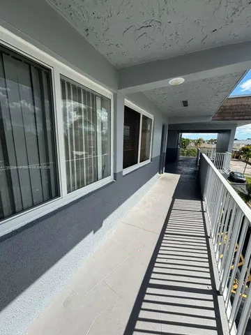 a kitchen with a sink cabinets and wooden floor
