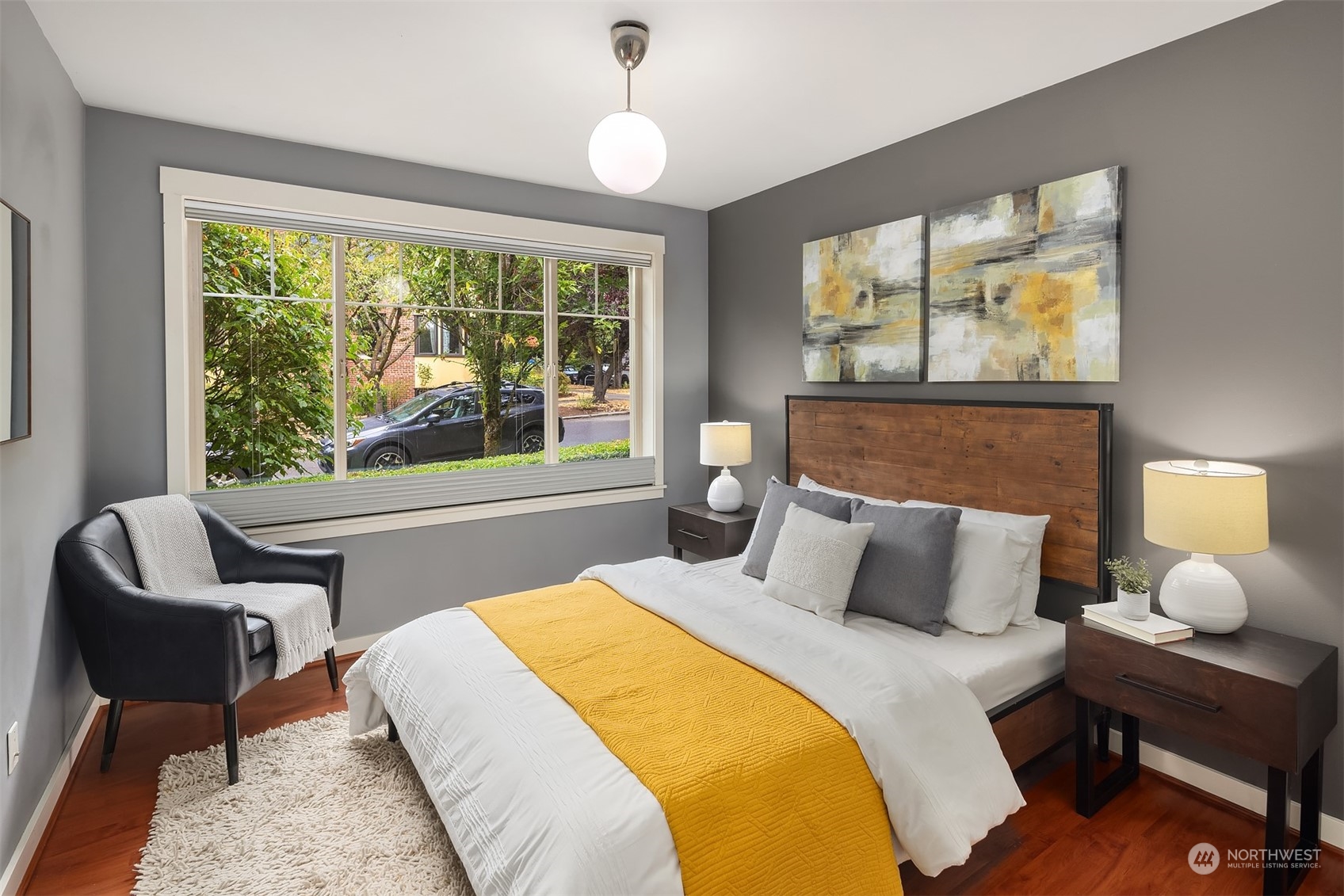 1621 East Spring Street, Unit 1B Seattle, WA 98122 - Photo 18 of 25 a bedroom with a bed and wooden floor