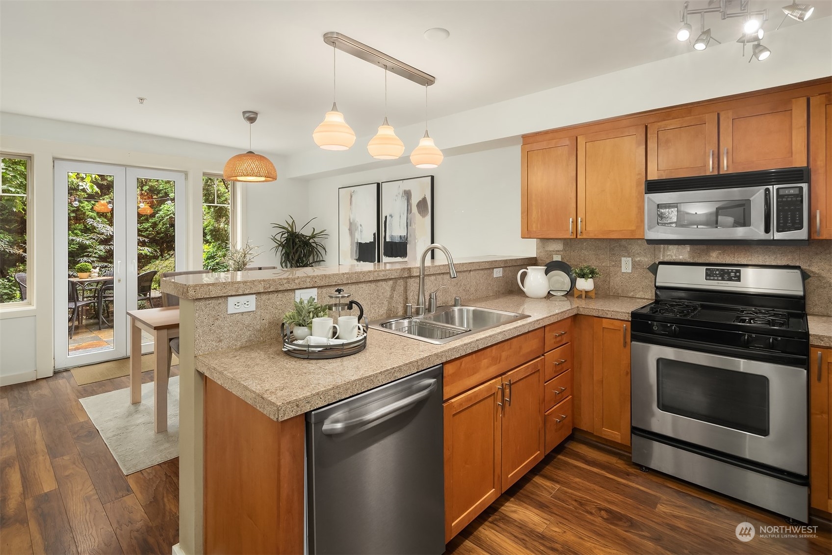 1621 East Spring Street, Unit 1B Seattle, WA 98122 - Photo 6 of 25 a kitchen with stainless steel appliances granite countertop a stove a sink and a microwave