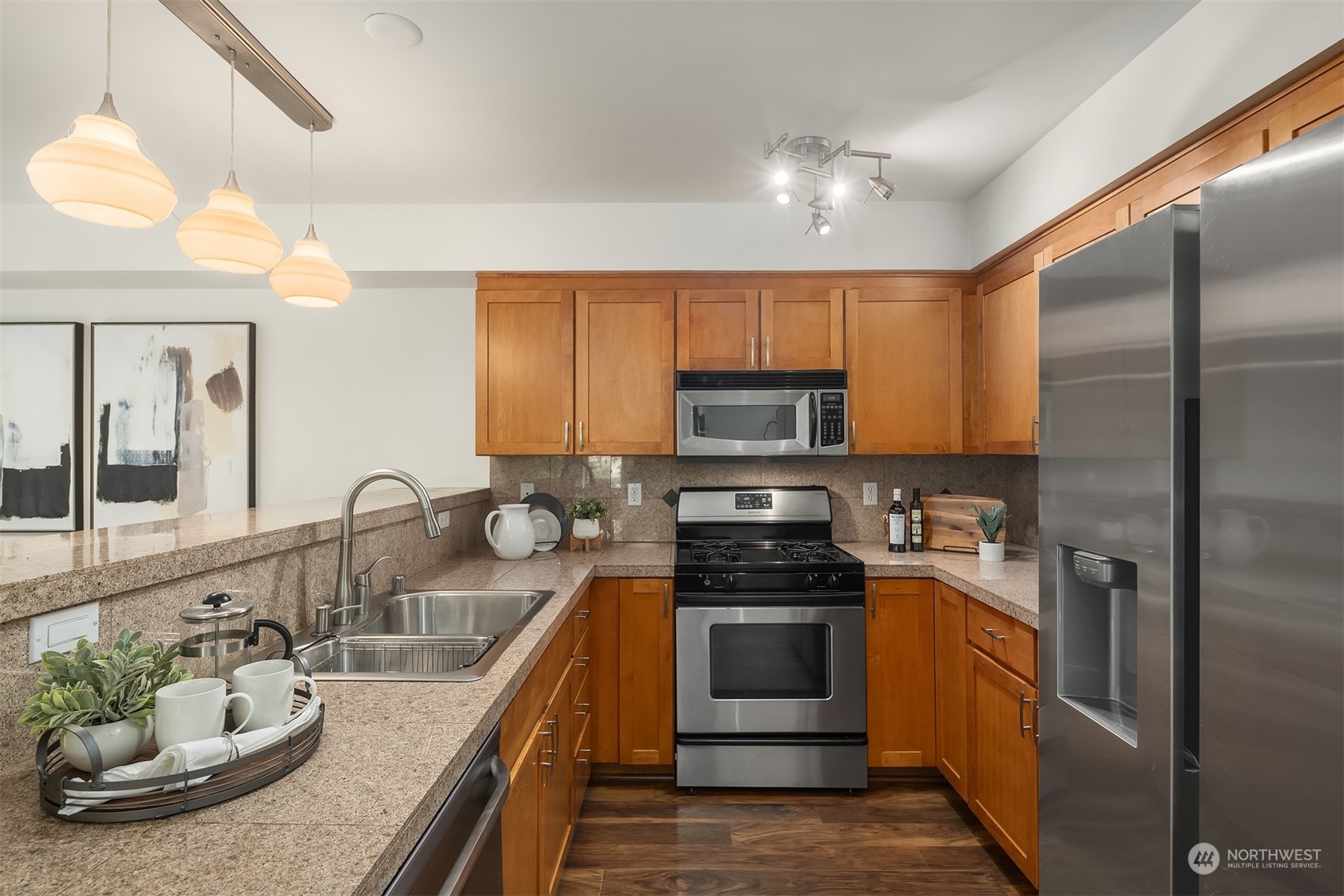1621 East Spring Street, Unit 1B Seattle, WA 98122 - Photo 7 of 25 a kitchen with stainless steel appliances granite countertop a sink a stove and a refrigerator
