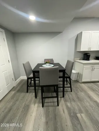 a dining room with furniture and wooden floor