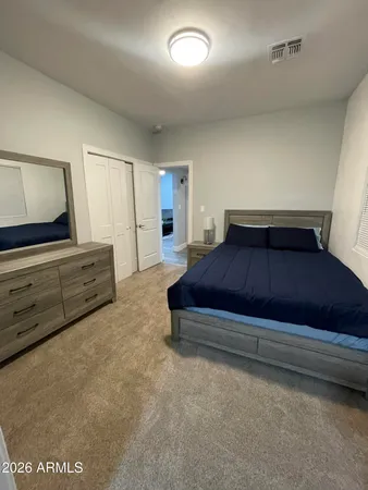 a bedroom with a bed and a dresser
