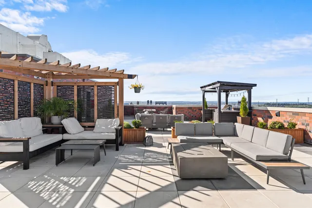 a living room with furniture a fireplace and a table