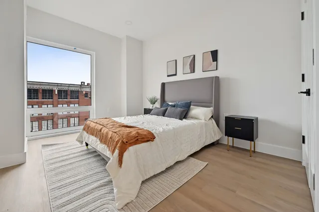a bedroom with a large bed and a window