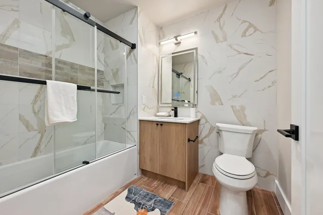 a bathroom with a sink toilet and shower