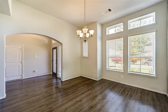 a view of a room with wooden floor and a window