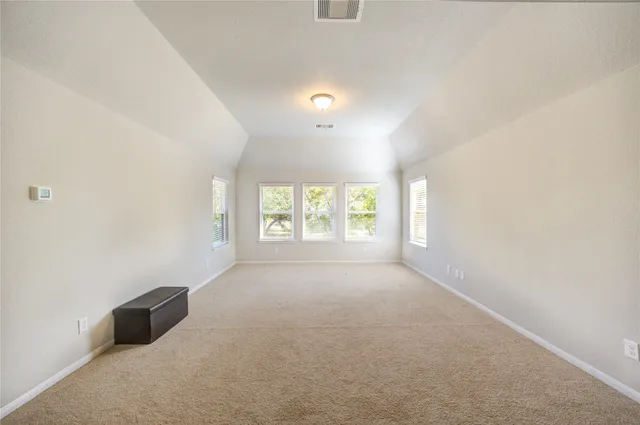 a front view of a house with a garden and yard