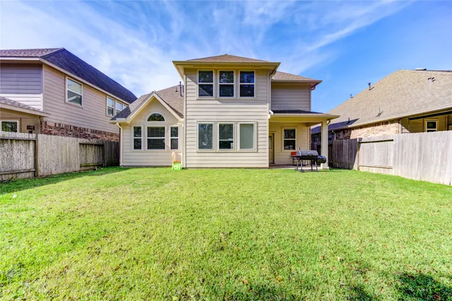 a backyard of a house with table and chairs