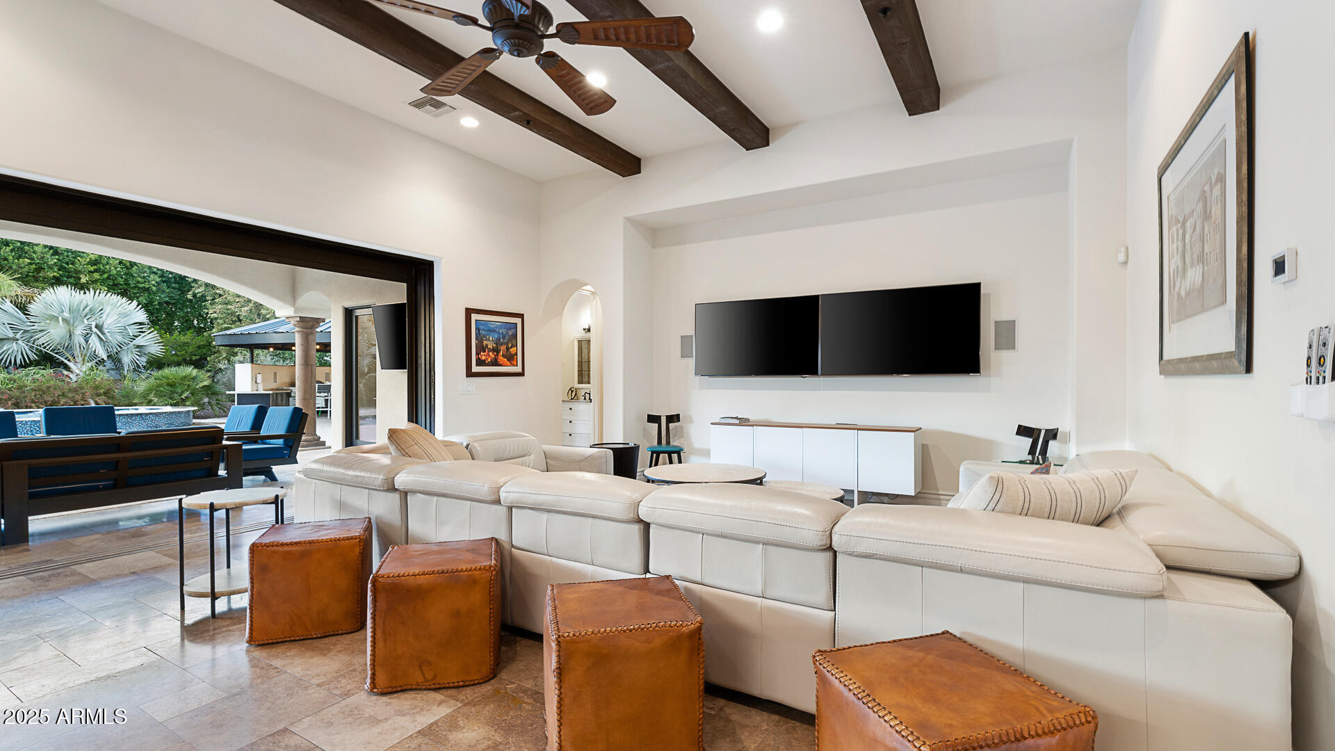 7120 North Quartz Mountain Road Paradise Valley, AZ 85253 - Photo 12 of 28 a living room with furniture a flat screen tv and a floor to ceiling window