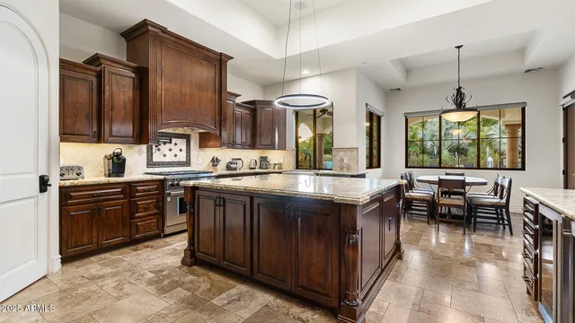 a kitchen with stainless steel appliances granite countertop a stove and a sink